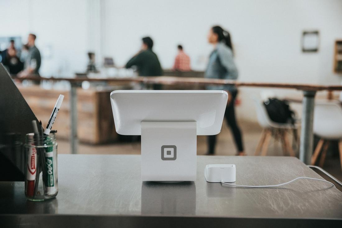 A Square Stand and card reader on a restaurant counter