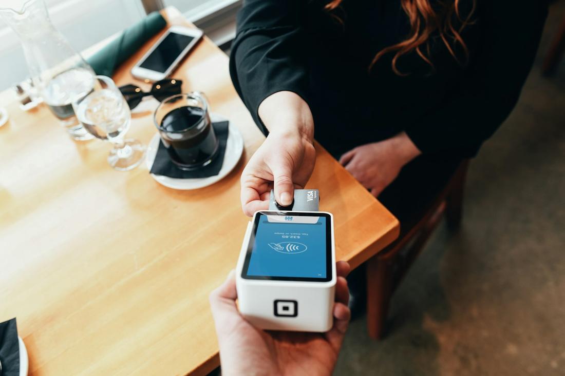 A guest paying at the table on a Square Terminal